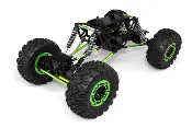 A green and black rock crawler is on the ground.