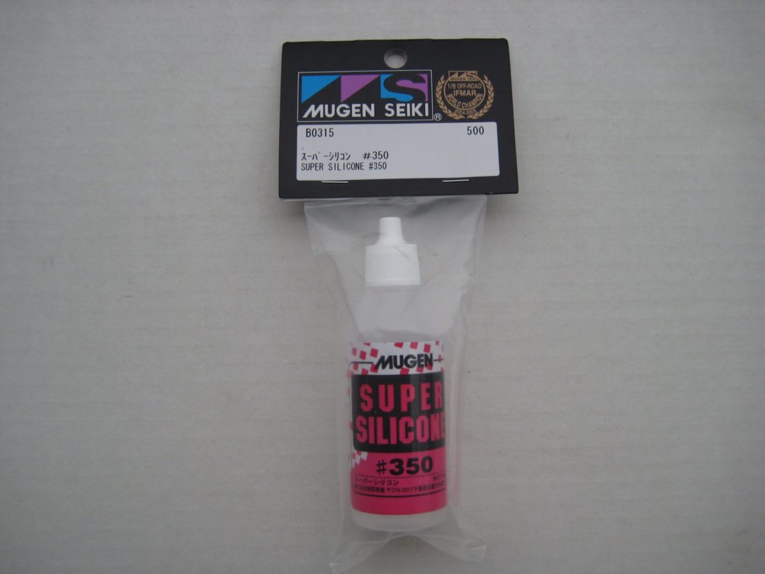 A bottle of pink liquid in its package.