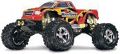 A red and yellow monster truck with large tires.