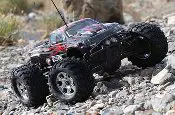 A remote controlled car is on the rocks.