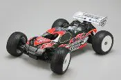 A red and black remote controlled car on the floor.