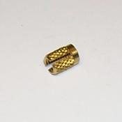 A piece of gold colored metal with a pattern.