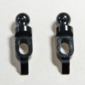 Two small black metal parts on display.