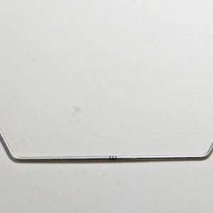 Bent metal wire on plain background.